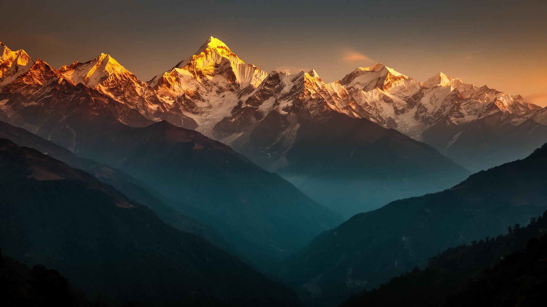 Snow-capped Himalayan peaks at golden hour